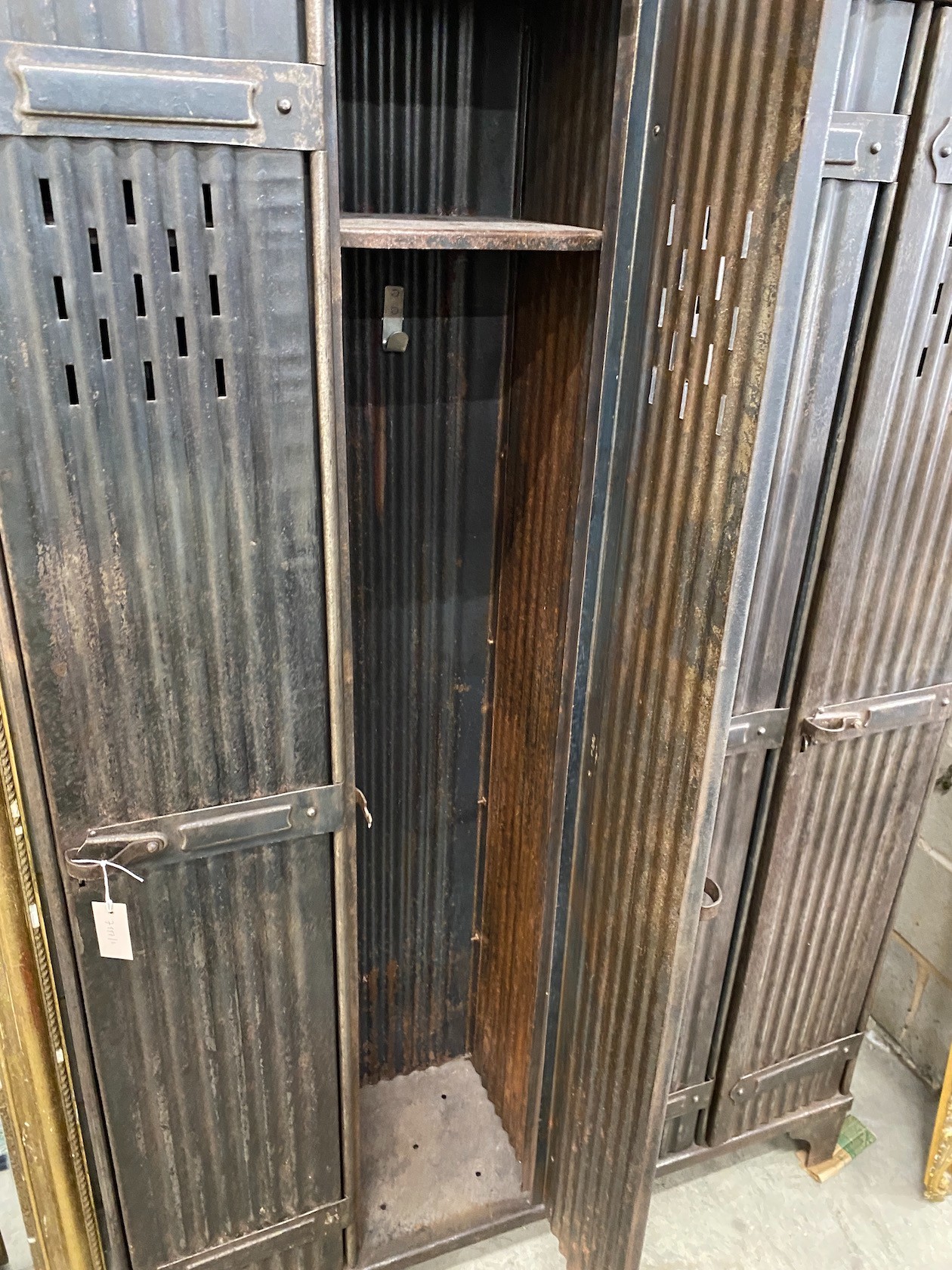 An industrial style metal four door locker, width 123cm, depth 33cm, height 184cm